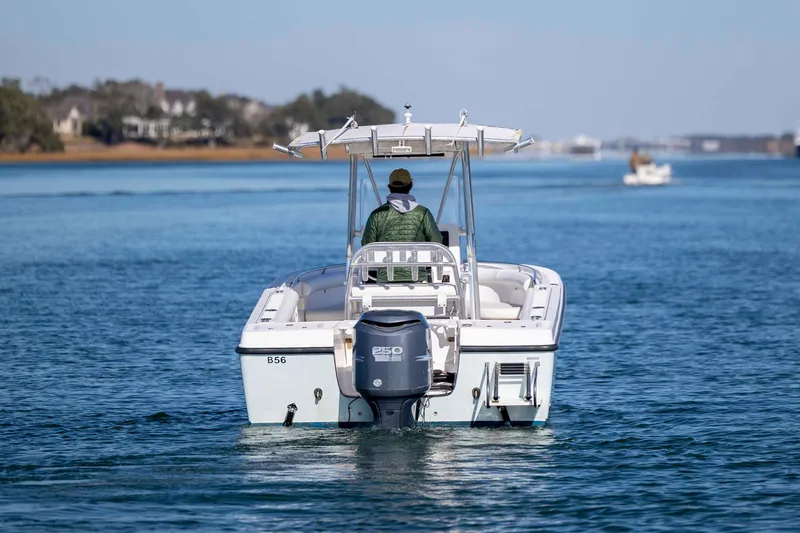 Slide: The Image of 2006 Edgewater 228CC boat cruising on a calm blue waterway. - 4
