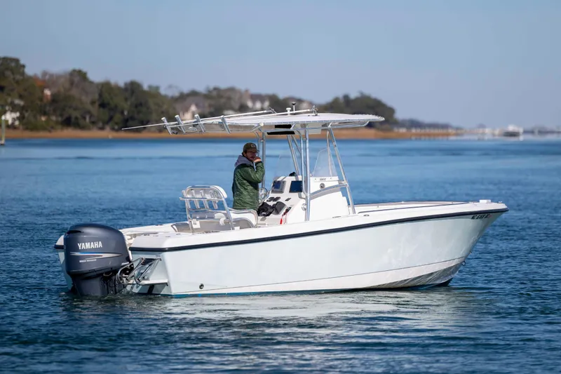 Slide: The Image of 2006 Edgewater 228CC boat on calm water with Yamaha outboard motor. - 5