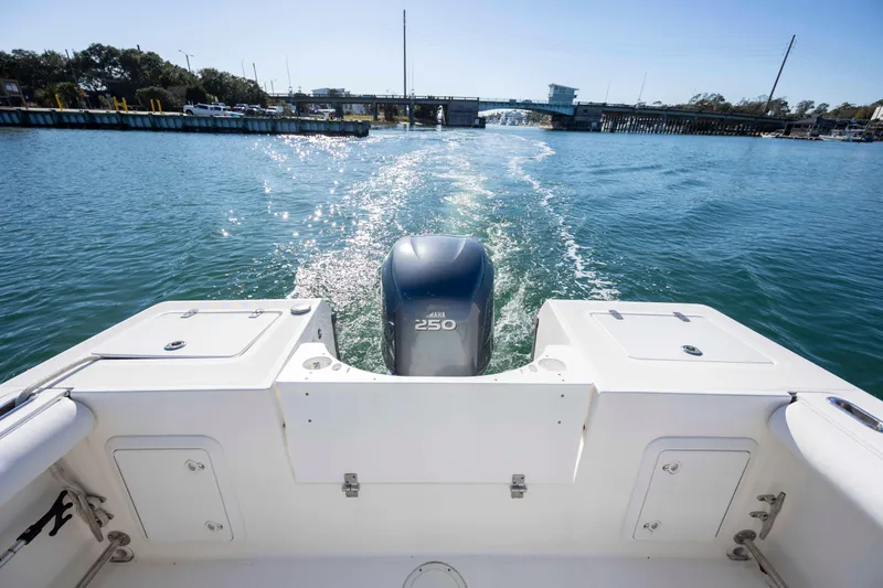 Slide: The Image of 2006 Edgewater 228CC boat cruising on a sunny day, leaving a wake behind. - 8