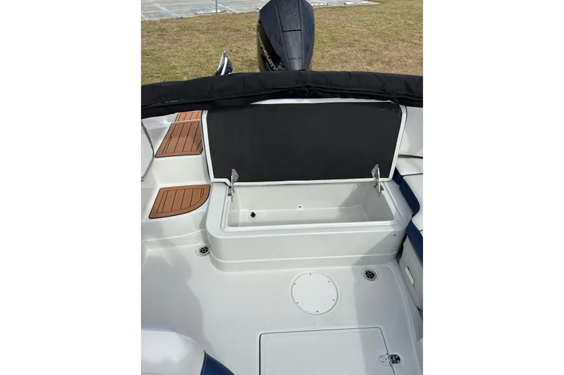 Slide: The Image of 2026 Crownline Eclipse E210 XS boat interior with storage compartment open. - 10