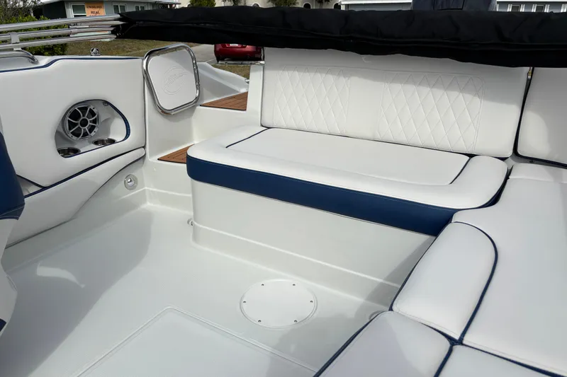Slide: The Image of 2026 Crownline Eclipse E210 XS boat interior with white and blue seating, speaker, and sleek design. - 12