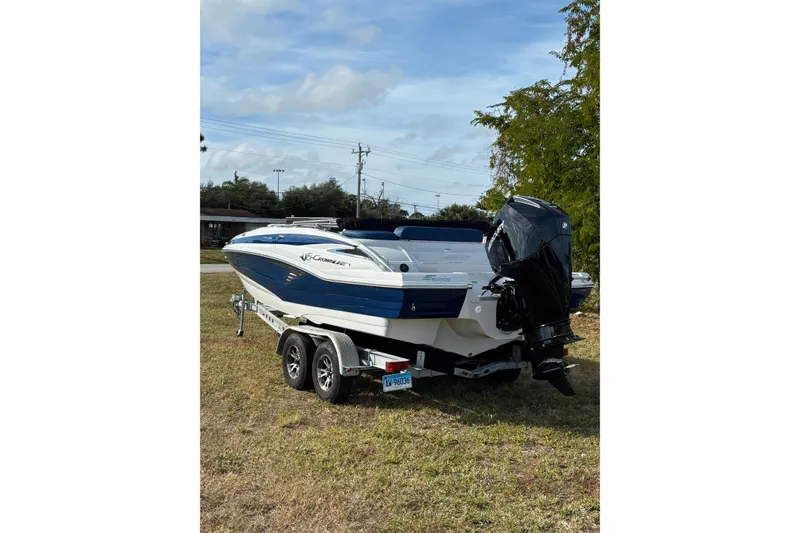 Slide: The Image of 2026 Crownline Eclipse E210 XS boat on trailer, parked on grass. - 17