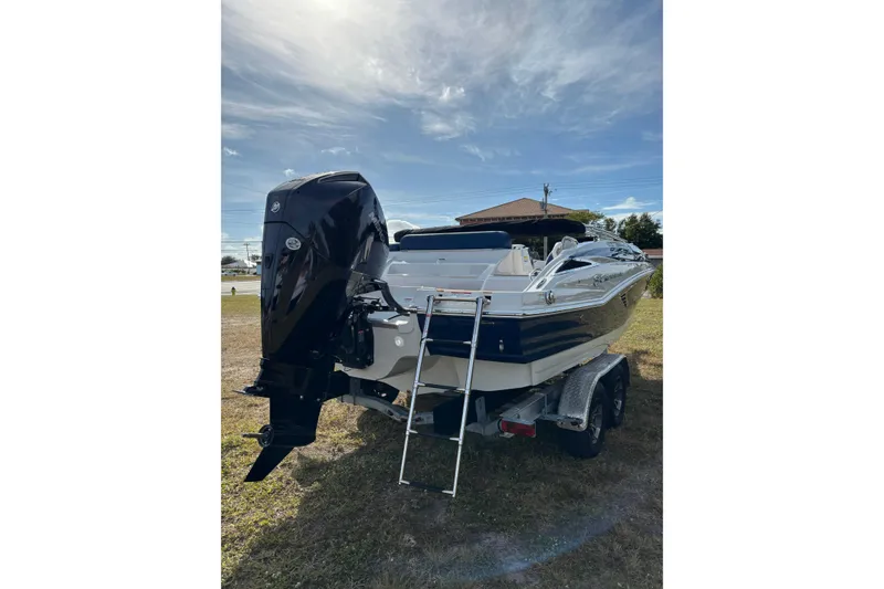 Slide: The Image of 2026 Crownline Eclipse E210 XS boat on trailer, rear view with outboard motor. - 26