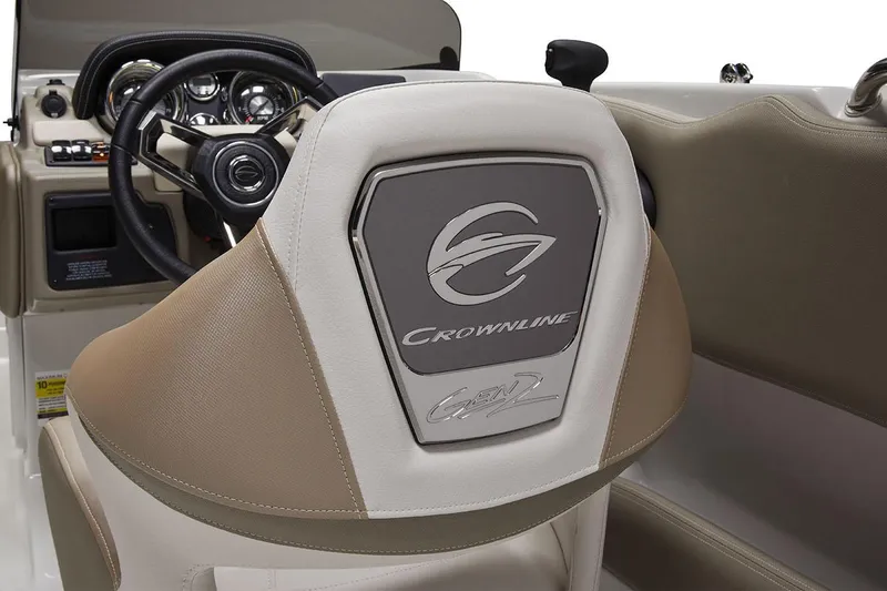 Slide: The Image of 2026 Crownline Eclipse E210 XS boat interior with open storage and Garmin dashboard. - 4