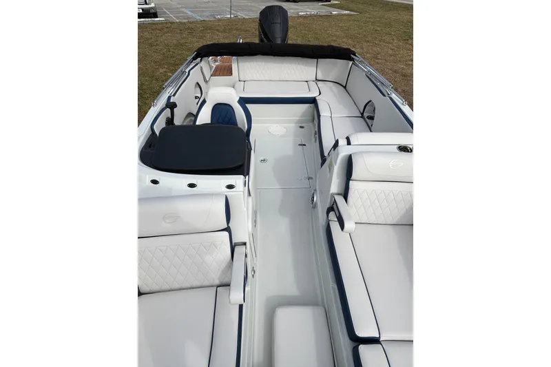 Slide: The Image of 2026 Crownline Eclipse E210 XS boat interior with white and navy seating. - 9