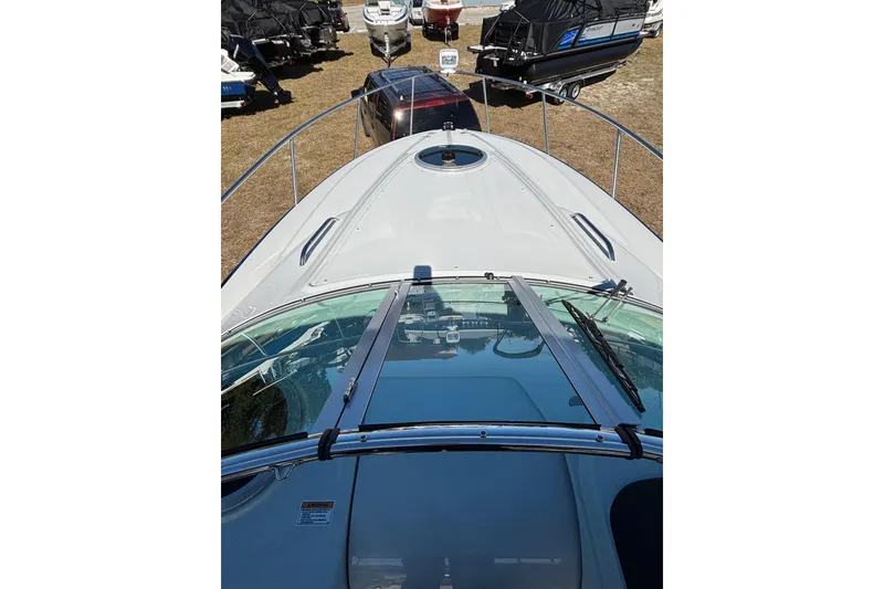Slide: The Image of 2026 Crownline 280 CRX boat deck view with surrounding parked boats. - 10