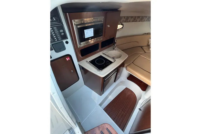 Slide: The Image of 2026 Crownline 280 CRX cabin interior with kitchenette and seating area. - 11