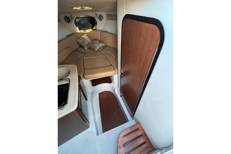 Slide: The Image of Interior of 2026 Crownline 280 CRX boat with cozy seating and wooden accents. - 12