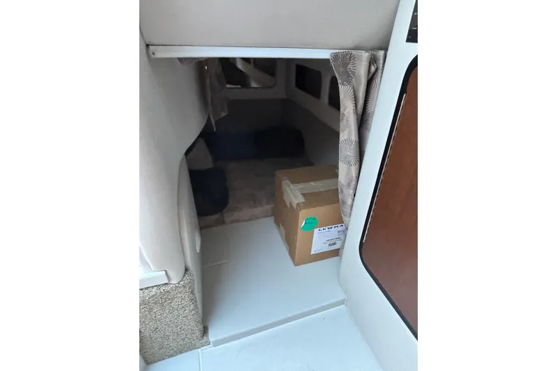 Slide: The Image of Interior cabin of 2026 Crownline 280 CRX boat with a cardboard box. - 14