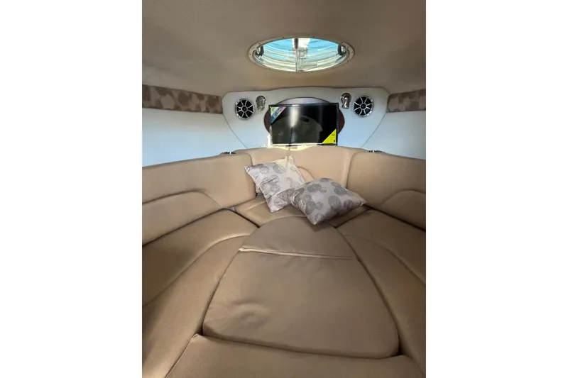 Slide: The Image of Interior of 2026 Crownline 280 CRX boat with beige seating and decorative pillows. - 16