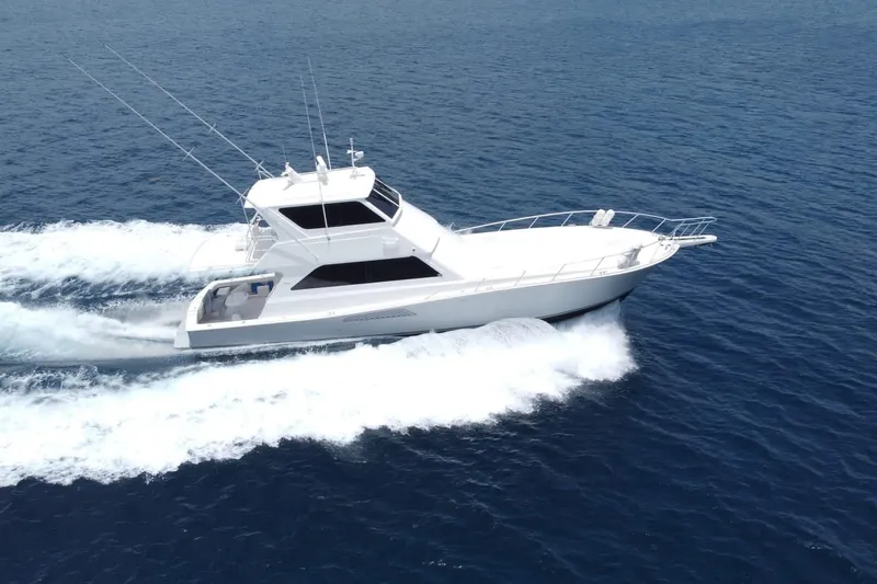 The Image of A 1999 Viking 58 Convertible yacht cruising swiftly on open blue waters. - 0