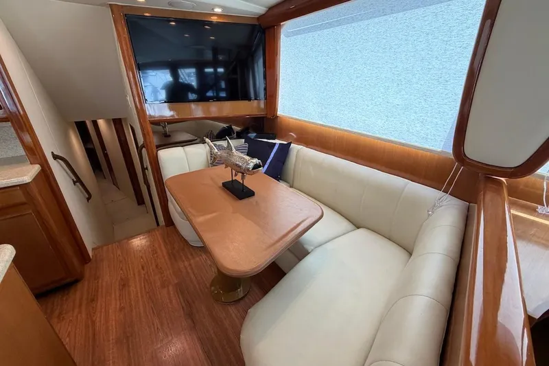 Slide: The Image of Luxurious interior of 1999 Viking 58 Convertible yacht with elegant seating and decor. - 10