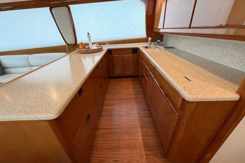 Slide: The Image of Luxurious kitchen interior of 1999 Viking 58 Convertible yacht with wooden cabinetry. - 12