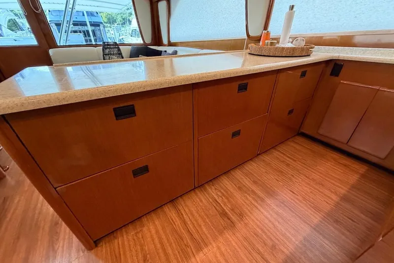 Slide: The Image of Interior of 1999 Viking 58 Convertible yacht with wooden cabinetry and countertop. - 13