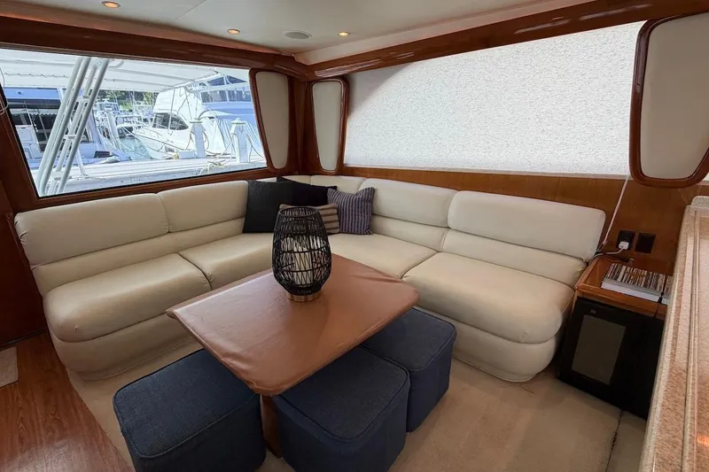 Slide: The Image of Luxurious interior of 1999 Viking 58 Convertible yacht with plush seating and elegant decor. - 14