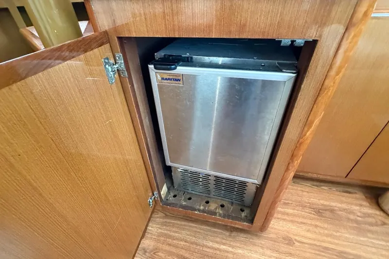 Slide: The Image of Raritan ice maker inside wooden cabinet on 1999 Viking 58 Convertible yacht. - 15