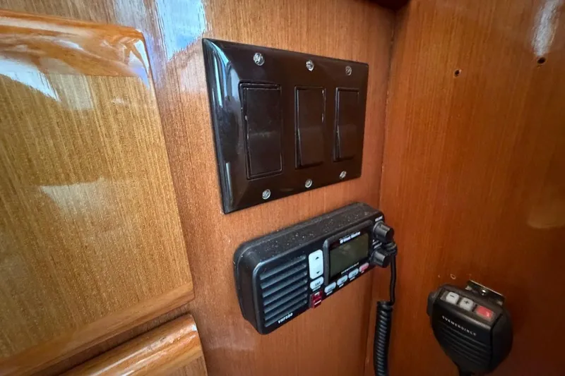 Slide: The Image of Control panel and radio on 1999 Viking 58 Convertible yacht's wooden interior. - 17