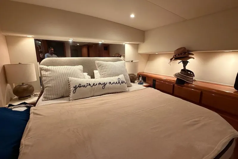 Slide: The Image of Cozy bedroom in 1999 Viking 58 Convertible yacht with decorative pillows and hats. - 19