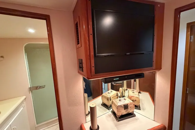 Slide: The Image of Interior of 1999 Viking 58 Convertible yacht with TV and bathroom view. - 20