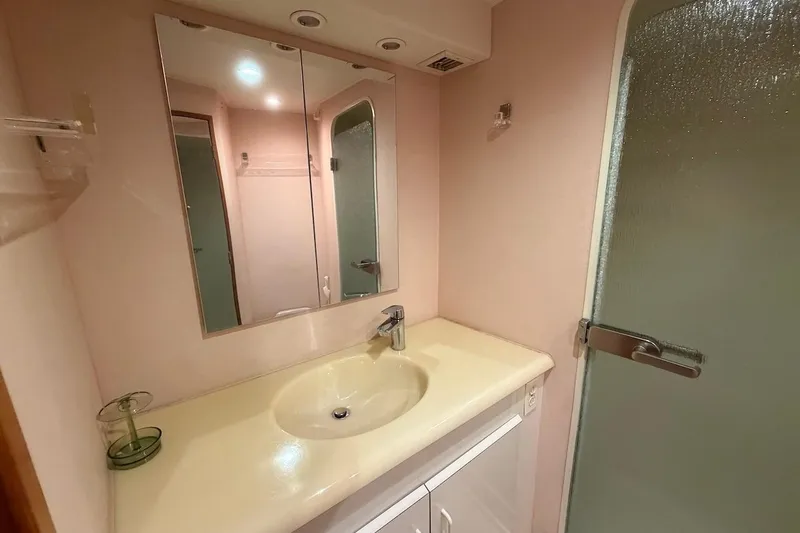 Slide: The Image of Bathroom interior of 1999 Viking 58 Convertible yacht with sink and shower. - 21