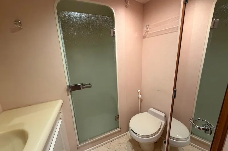 Slide: The Image of Bathroom interior of 1999 Viking 58 Convertible yacht with shower and toilet. - 22