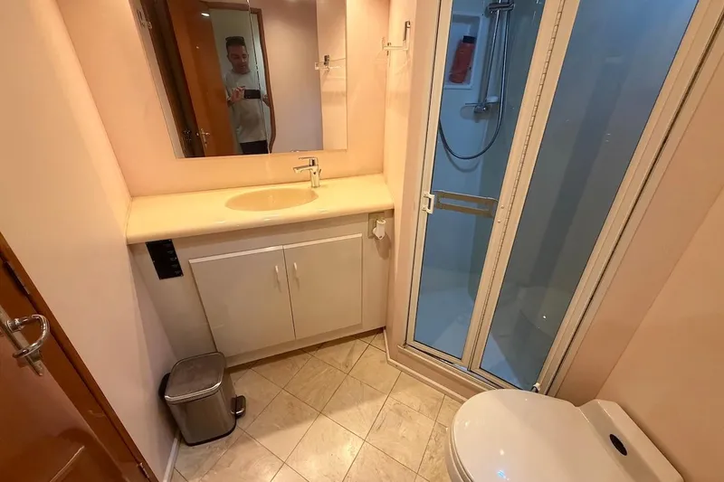 Slide: The Image of Bathroom interior of 1999 Viking 58 Convertible yacht with shower and vanity. - 25