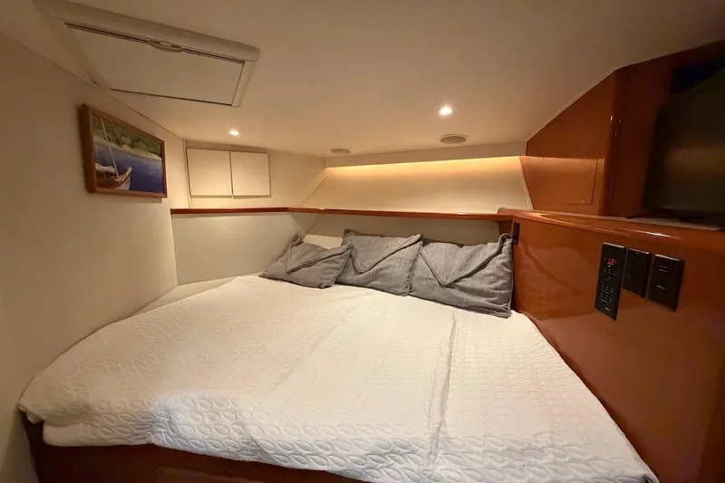Slide: The Image of Cozy cabin interior of 1999 Viking 58 Convertible yacht with bed and soft lighting. - 26