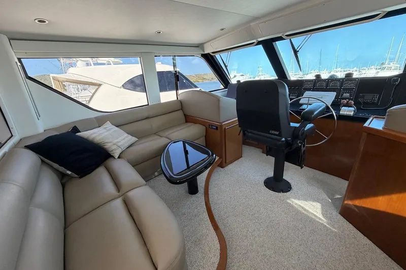 Slide: The Image of Luxurious interior of 1999 Viking 58 Convertible yacht with plush seating and helm. - 29