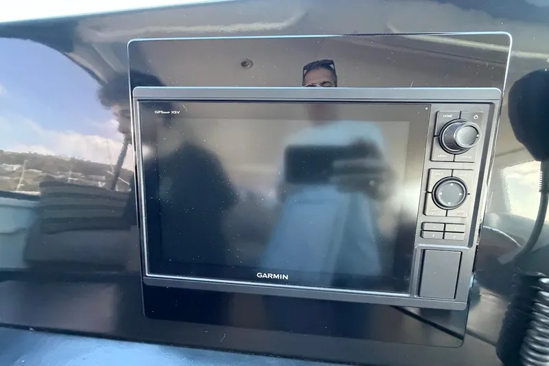 Slide: The Image of Garmin GPS device on 1999 Viking 58 Convertible yacht dashboard. - 32