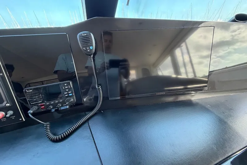 Slide: The Image of Control panel of a 1999 Viking 58 Convertible yacht with radio and screen. - 34