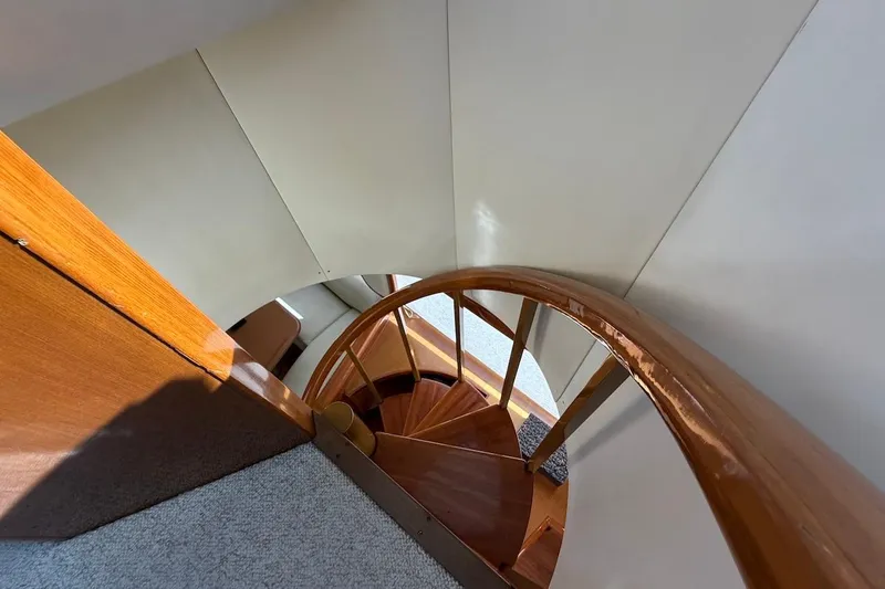 Slide: The Image of Curved wooden staircase inside 1999 Viking 58 Convertible yacht. - 37