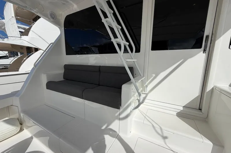 Slide: The Image of Interior view of 1999 Viking 58 Convertible yacht with seating and ladder. - 4