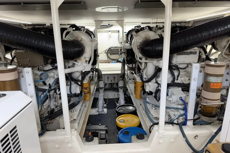 Slide: The Image of Engine room of a 1999 Viking 58 Convertible yacht, showcasing dual engines and components. - 40