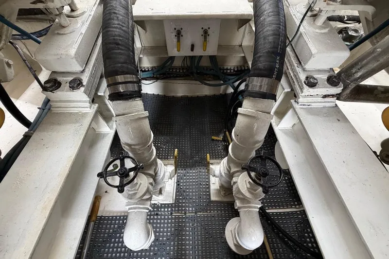 Slide: The Image of Engine room of 1999 Viking 58 Convertible yacht with visible piping and valves. - 47