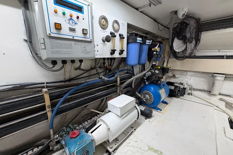 Slide: The Image of Engine room of 1999 Viking 58 Convertible yacht with water filtration system and control panel. - 49