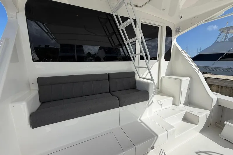 Slide: The Image of 1999 Viking 58 Convertible yacht with gray seating and ladder on deck. - 5