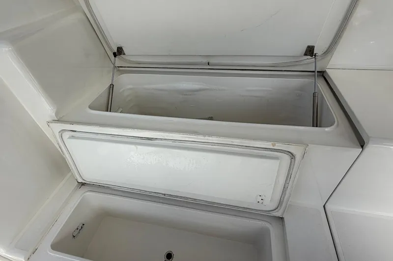 Slide: The Image of Open storage compartment on a 1999 Viking 58 Convertible boat. - 6