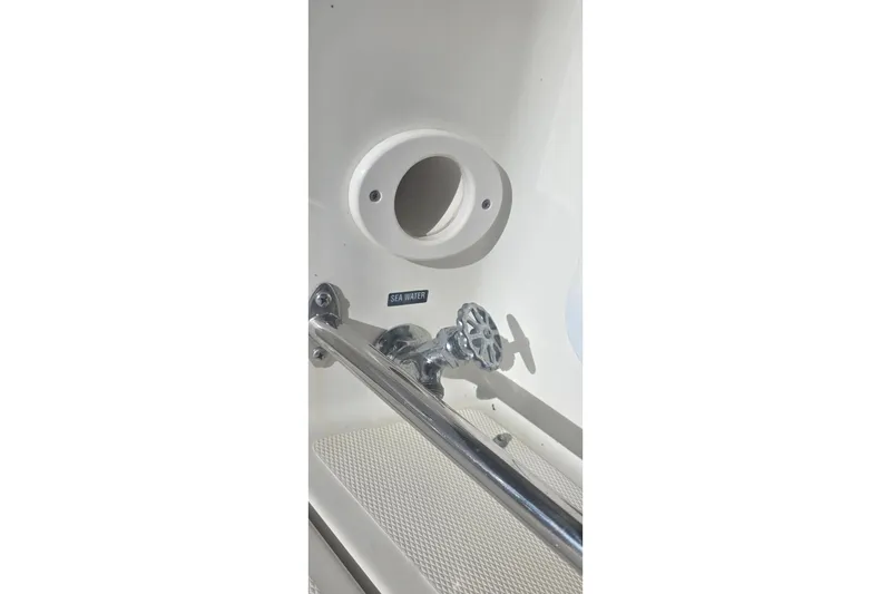 Slide: The Image of 2006 Sea Ray 290 Amberjack kitchen with microwave, sink, and compact fridge. - 21