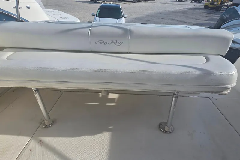 Slide: The Image of 2006 Sea Ray 290 Amberjack cabin interior with kitchenette and cozy seating area. - 23