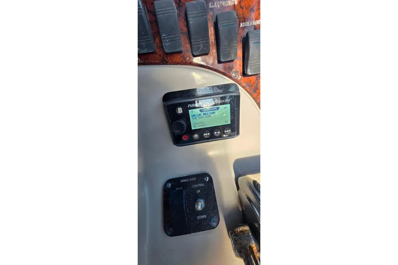 Slide: The Image of 2006 Sea Ray 290 Amberjack interior detail with storage compartment and hinge. - 28