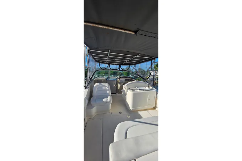 Slide: The Image of 2006 Sea Ray 290 Amberjack boat, rear view, parked outdoors under cloudy sky. - 3