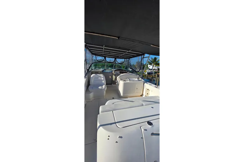 Slide: The Image of 2006 Sea Ray 290 Amberjack boat with canopy under clear blue sky. - 4