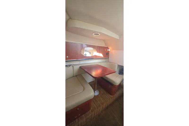 Slide: The Image of 2006 Sea Ray 290 Amberjack boat interior with storage compartment and seating. - 7