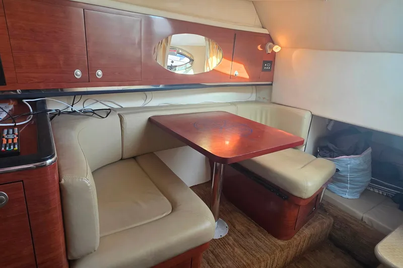 Slide: The Image of 2006 Sea Ray 290 Amberjack boat interior with white seating and control panel. - 8