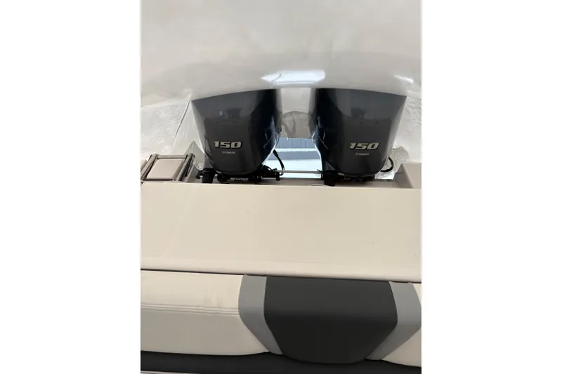 Slide: The Image of 2023 Robalo R250 Center Console with dual Yamaha 150 engines, rear view. - 13