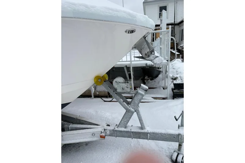 Slide: The Image of 2023 Robalo R250 Center Console boat on snowy trailer in winter setting. - 14