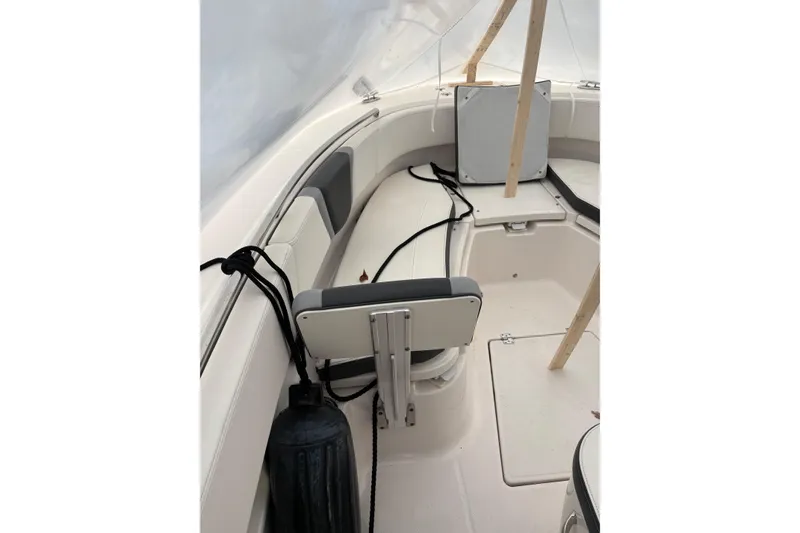 Slide: The Image of 2023 Robalo R250 Center Console boat interior with seating and storage. - 17