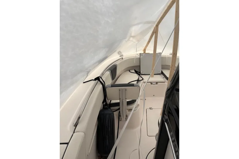 Slide: The Image of 2023 Robalo R250 Center Console boat interior under protective cover. - 30
