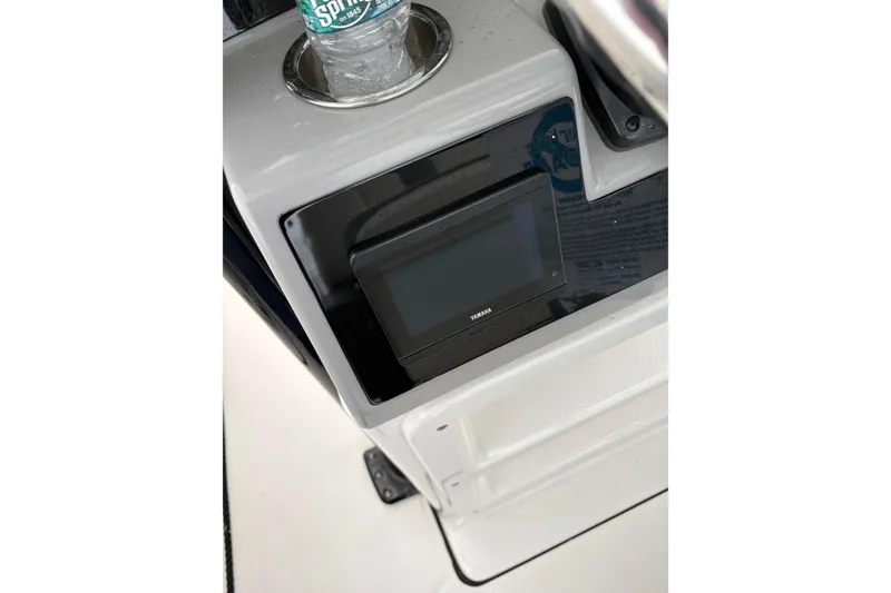 Slide: The Image of 2023 Robalo R250 Center Console dashboard with Yamaha display and cup holder. - 32