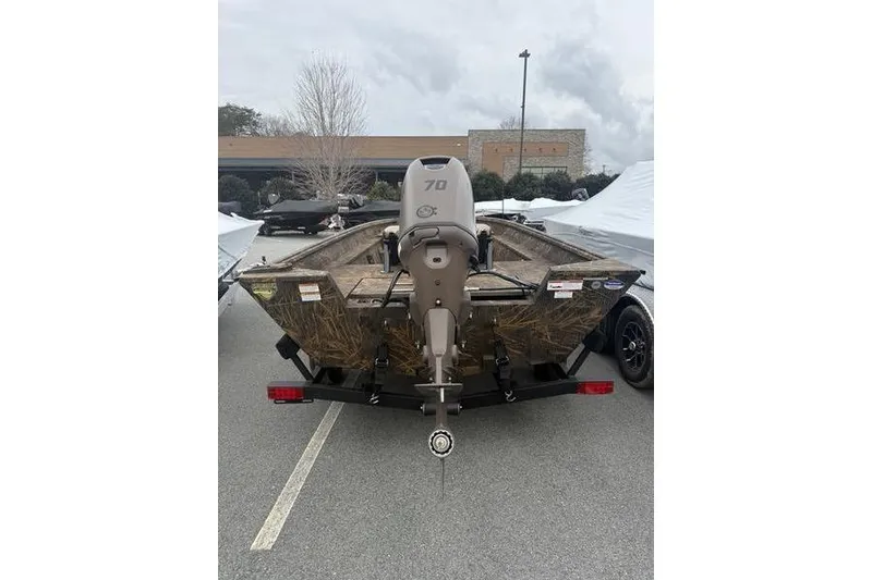 Slide: The Image of Outdoor store with parking lot, featuring a 2026 G3 Gator Tough 17 CC boat. - 11